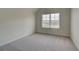A basic bedroom with carpeted floors and natural light from the window at 1816 Kingsmere Run Dr, Loganville, GA 30052