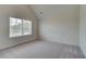 Bright bedroom with neutral carpet and large window with blinds at 1816 Kingsmere Run Dr, Loganville, GA 30052