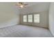 Spacious bedroom with vaulted ceiling and lots of natural light from three windows at 1816 Kingsmere Run Dr, Loganville, GA 30052