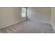 A basic bedroom with carpeted floors and natural light from the window at 1816 Kingsmere Run Dr, Loganville, GA 30052