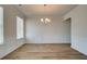Spacious, bright dining room featuring modern chandelier, wainscoting, and wood-look flooring at 1816 Kingsmere Run Dr, Loganville, GA 30052