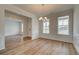 Open concept dining room features wood-look flooring, wainscoting and modern light fixture at 1816 Kingsmere Run Dr, Loganville, GA 30052