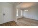 Bright dining room area with new wood-look floors, modern light fixture, and large windows at 1816 Kingsmere Run Dr, Loganville, GA 30052