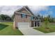 Elegant two-story brick home with a spacious layout, featuring a well-maintained lawn and an attached garage at 1816 Kingsmere Run Dr, Loganville, GA 30052