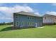 Back exterior of home with ample yard space and blue siding at 1816 Kingsmere Run Dr, Loganville, GA 30052
