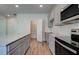 Kitchen featuring stainless steel appliances, gray cabinets, and a pantry at 1816 Kingsmere Run Dr, Loganville, GA 30052