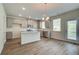 Bright kitchen featuring grey cabinets, granite countertops, stainless steel appliances, island and hardwood-style floors at 1816 Kingsmere Run Dr, Loganville, GA 30052