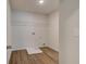 Laundry room with wood-look floors and washer hookups at 1816 Kingsmere Run Dr, Loganville, GA 30052