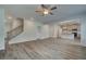 Spacious living room featuring wood-look flooring, open floor plan, and seamless connection to the kitchen and staircase at 1816 Kingsmere Run Dr, Loganville, GA 30052