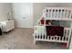 This bedroom is equipped with a white bunk bed, a dresser, and carpeted floors at 2670 Greenbelt Rd, Snellville, GA 30078