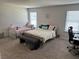 Cozy bedroom showcasing two beds, natural light, and a comfortable workspace at 2670 Greenbelt Rd, Snellville, GA 30078