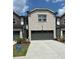 Two-story exterior elevation with a gray brick facade and a two-car garage at 2670 Greenbelt Rd, Snellville, GA 30078