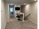 Open hallway space featuring carpeting and a built-in study nook with an adjacent staircase at 2670 Greenbelt Rd, Snellville, GA 30078