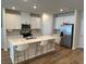 Modern kitchen boasts an island with seating and stainless steel appliances at 2670 Greenbelt Rd, Snellville, GA 30078