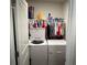 Functional laundry room with a washer, dryer, and clothing rack with ample hanging space at 2670 Greenbelt Rd, Snellville, GA 30078