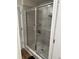 The tiled shower is equipped with sliding glass doors and a built-in shelf at 2670 Greenbelt Rd, Snellville, GA 30078