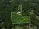 An aerial view showcases the home's secluded setting amidst mature trees at 450 Dorset Sw Way, Smyrna, GA 30082