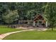 Outdoor entertaining area with stone fireplace, pergola, and ample seating at 450 Dorset Sw Way, Smyrna, GA 30082