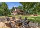 A well-kept lawn, mature trees, and an inviting stone fire pit set the scene for outdoor enjoyment at 450 Dorset Sw Way, Smyrna, GA 30082