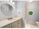Bright bathroom with round window, neutral color, and modern vanity with cabinet storage at 450 Dorset Sw Way, Smyrna, GA 30082