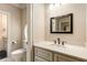 Bathroom with tan walls, toilet in separate room and sink with cabinet storage at 450 Dorset Sw Way, Smyrna, GA 30082
