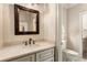 Elegant powder room with custom vanity, stone countertop, and decorative mirror at 450 Dorset Sw Way, Smyrna, GA 30082