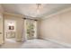 Light-filled bedroom with neutral carpet, chandelier and view into bathroom with neutral colors at 450 Dorset Sw Way, Smyrna, GA 30082