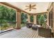 Comfortable covered deck with wicker furniture and a view of the wooded backyard at 450 Dorset Sw Way, Smyrna, GA 30082