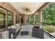 Large covered deck with outdoor furniture and a view of the lush green backyard and landscaping at 450 Dorset Sw Way, Smyrna, GA 30082
