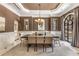 Formal dining room features wainscoting, stylish chandelier, and large arched window at 450 Dorset Sw Way, Smyrna, GA 30082