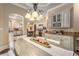 Formal dining room featuring elegant chandelier, light colored walls and trim, and a view into the kitchen at 450 Dorset Sw Way, Smyrna, GA 30082