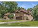 Brick home showcasing architectural detail, a three car garage, and lush landscaping at 450 Dorset Sw Way, Smyrna, GA 30082