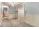 Hallway with light blue walls, wainscoting, and view into bedroom with chandelier and neutral carpet at 450 Dorset Sw Way, Smyrna, GA 30082