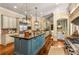 Expansive kitchen featuring a central island, custom range hood, and seamless flow to the breakfast and dining areas at 450 Dorset Sw Way, Smyrna, GA 30082
