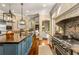 Chef's kitchen with a large center island, custom range hood, and flowing seamlessly to breakfast nook and living areas at 450 Dorset Sw Way, Smyrna, GA 30082