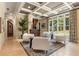 Sun-filled formal living area with coffered ceilings, large windows, and a decorative wet bar for entertaining guests at 450 Dorset Sw Way, Smyrna, GA 30082