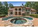 Resort style pool area with spa, stone patio, and covered veranda at 450 Dorset Sw Way, Smyrna, GA 30082