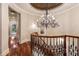 Staircase landing with a chandelier and railing overlooking the first floor at 450 Dorset Sw Way, Smyrna, GA 30082