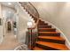 Elegant curved staircase with wood treads and wrought iron railing leads to upper level at 450 Dorset Sw Way, Smyrna, GA 30082
