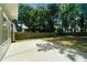 This backyard features a concrete patio, lush green lawn and privacy fence at 11660 Windbrooke Way, Johns Creek, GA 30005
