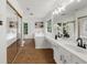 Bright bathroom showcasing soaking tub, vanity with dual mirrors, and tile floor at 11660 Windbrooke Way, Johns Creek, GA 30005