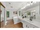 This bathroom features tile floors, a garden tub and vanity with dual mirrors at 11660 Windbrooke Way, Johns Creek, GA 30005