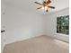 This bedroom features a ceiling fan, and a window providing natural light at 11660 Windbrooke Way, Johns Creek, GA 30005