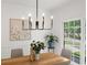 Well-lit dining room with view of landscaped yard at 11660 Windbrooke Way, Johns Creek, GA 30005