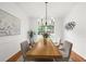 Bright dining room with wood table, decorative lighting, and large window at 11660 Windbrooke Way, Johns Creek, GA 30005