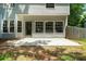 A rear exterior view features a concrete patio, lots of windows and a privacy fence at 11660 Windbrooke Way, Johns Creek, GA 30005