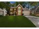 Beautiful brick fronted two-story home with well-maintained lawn and attached garage at 11660 Windbrooke Way, Johns Creek, GA 30005