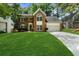 Charming brick home features a manicured lawn, a two-car garage and beautiful curb appeal at 11660 Windbrooke Way, Johns Creek, GA 30005