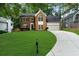 Traditional brick home boasts an immaculate lawn, a paved driveway and a welcoming entrance at 11660 Windbrooke Way, Johns Creek, GA 30005