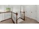 Hallway with carpeted stairs and wooden railing at 11660 Windbrooke Way, Johns Creek, GA 30005